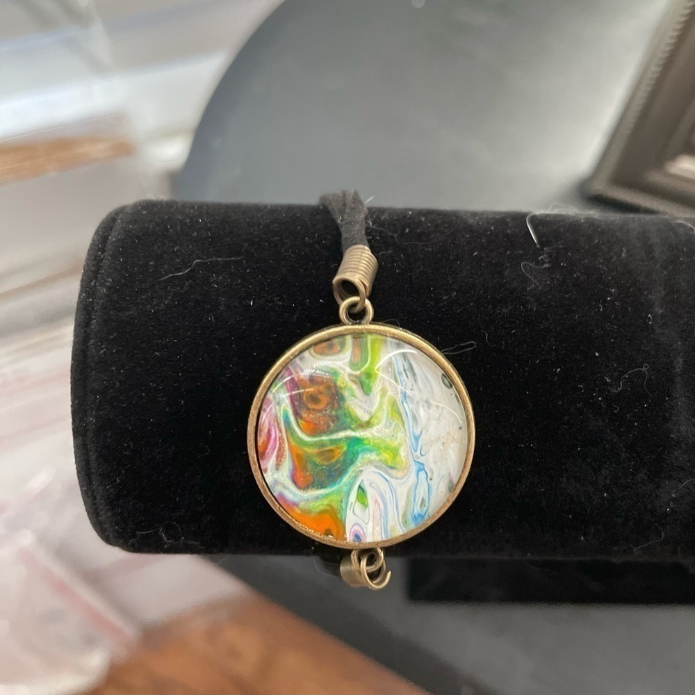 Hand painted acrylic on glass & attached to metal.  Adjustable